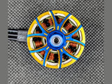 Detail of AOS RC Supernova 2810 motor with gold outer ring, radial spokes, and black wires