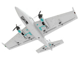 Underside view of AtomRC Beluga FPV plane highlighting teal motor mounts and wiring paths
