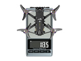 Flywoo Firefly 25 Mini O4 Pro drone on scale showing 113.5g weight